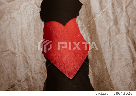 Torn wrinkled paper on heart.  Valentine concept 98643926
