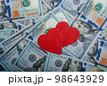 Red hearts on a background of dollar  banknotes 98643929