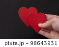 Hand holding red hearts . Valentine concept and promise of love. 98643931