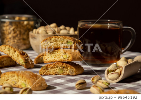 Biscotti Cantuccini Cookie Biscuits with pistachios and lemon peel Shortbread. Cup of tea. Teatime break Healthy eating food. Homemade fresh Italian cookies cantucci stacks and organic pistachios nuts 98645192