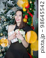 Lovely woman with gifts in hands 98645542