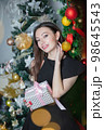 Attractive woman with gifts in hands 98645543