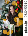 Charming woman with gifts in hands 98645549