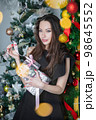 Pretty brunette with gifts in hands 98645552