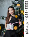 Beautiful woman with gifts in hands 98645553