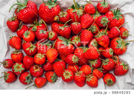 Close up of strawberrys,Woman holding fresh strawberries in hands Close up of strawberrys,Woman holding fresh strawberries in hands 98649285