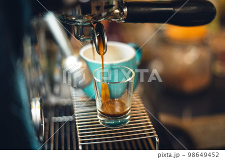 Wonderful espresso shot pouring out Wonderful espresso shot pouring out 98649452