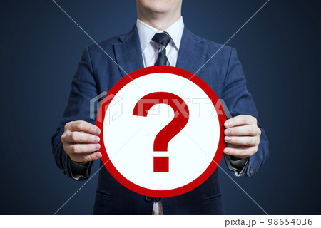 Businessman holding a poster 'question mark' Businessman holding a poster 'question mark' 98654036