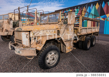 Old abandoned and rusty sand colored military truck 98656691