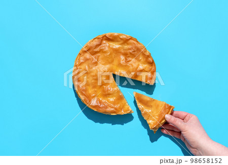 Savory pie with spinach and feta cheese, above view. Balkan phyllo cake Savory pie with spinach and feta cheese, above view. Balkan phyllo cake 98658152