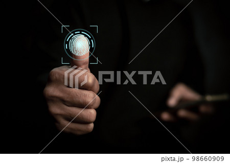 Businessman scans fingerprints and confirm biometric identity..Concept of the future of security and password control through fingerprints in an immersive technology future and cybernetic. Businessman scans fingerprints and confirm biometric identity..Concept of the future of security and password control through fingerprints in an immersive technology future and cybernetic. 98660909