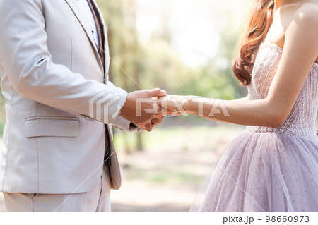 Wedding theme background, hug and holding hands newlyweds in celebration marriage day 98660973