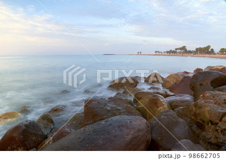 Rocky beach at sunrise, colors 98662705