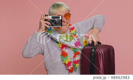 Woman tourist photographer taking photos on retro camera and smiling, travel summer holiday vacation Woman tourist photographer taking photos on retro camera and smiling, travel summer holiday vacation 98662983