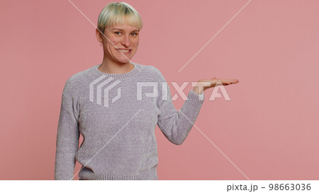 Woman pointing empty place, advertising area for commercial text, copy space for goods promotion 98663036