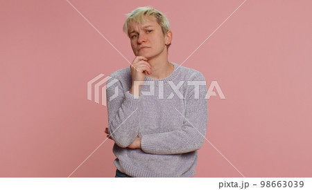 Thoughtful clever woman pondering a solution, doubting question, rubbing chin, pensive expression 98663039