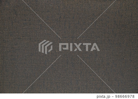 Background: rough brown fabric with blank space for lettering 98666978