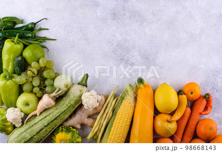 Assortment of yellow and red vegetables and fruits 98668143