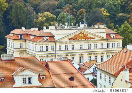 High angle view of Embassy of Germany by autumn trees in Prague, Czech Republic. High angle view of Embassy of Germany by autumn trees in Prague, Czech Republic. 98668854