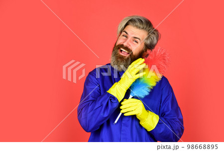 Dust allergy. Polypropylene duster. Hipster holding cleaning tool. Cleaning service. Cleaning home concept. Small colorful duster broom. Housekeeping duties. Cleaning apartment. Man use pp duster Dust allergy. Polypropylene duster. Hipster holding cleaning tool. Cleaning service. Cleaning home concept. Small colorful duster broom. Housekeeping duties. Cleaning apartment. Man use pp duster 98668895