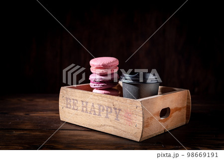 Be happy with coffee and cookies. Cheer up with coffee and sweets. Coffee and cookies in a box. Low key. 98669191