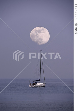 Sailboat sailing on the sea with the moon Sailboat sailing on the sea with the moon 98669641