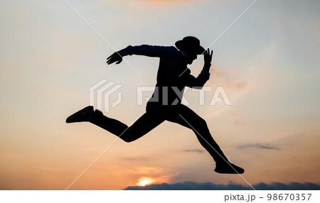 silhouette of man running in sense of freedom on sunrise sky, stamina silhouette of man running in sense of freedom on sunrise sky, stamina 98670357