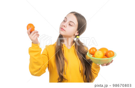 try it. healthy life. diet and kid skin beauty. girl with citrus fruit plate. vitamin and dieting. 98670803