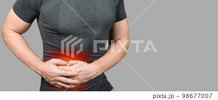 Abdominal Pain. Man touching stomach painful suffering from stomachache causes gastric ulcer, appendicitis or gastrointestinal system disease. 98677007