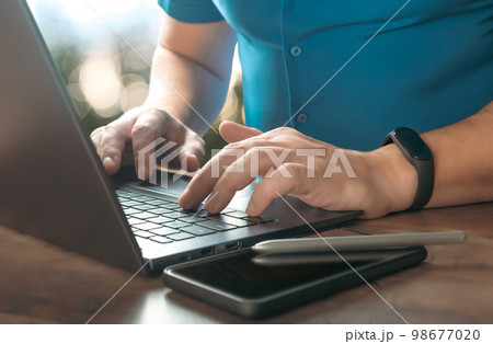 Close-up partial view of businessman typing on laptop at workplace. businessman using laptop. Cropped image Searching browsing internet Data information Close-up partial view of businessman typing on laptop at workplace. businessman using laptop. Cropped image Searching browsing internet Data information 98677020