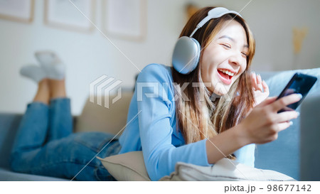 Happy young asian woman relaxing at home 98677142