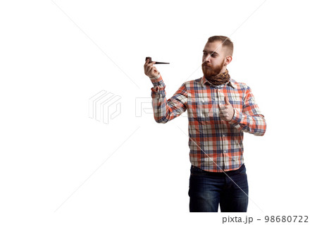 Handsome beard redhead man in checked shirt with thumb up shows smoking pipe on white background 98680722