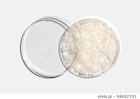 Flake salt in Petri dish with plastic lid on white laboratory table. Chemical ingredient for Cosmetics and Toiletries product. Top View Flake salt in Petri dish with plastic lid on white laboratory table. Chemical ingredient for Cosmetics and Toiletries product. Top View 98682595