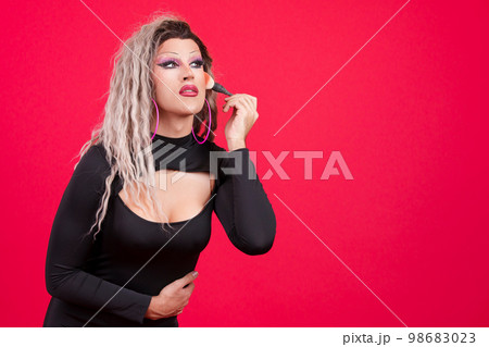 Transgender person dressed as drag queen making up Transgender person dressed as drag queen making up 98683023