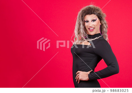 Slim transgender person smiling at camera while posing Slim transgender person smiling at camera while posing 98683025