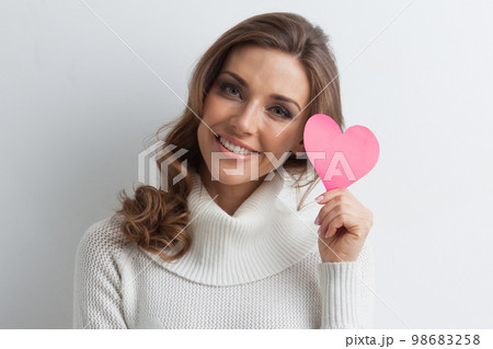 Smiling woman with paper heart Smiling woman with paper heart 98683258