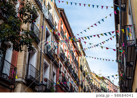 Street decorated with pennants in the traditional neighborhood of Embajadores 98684041