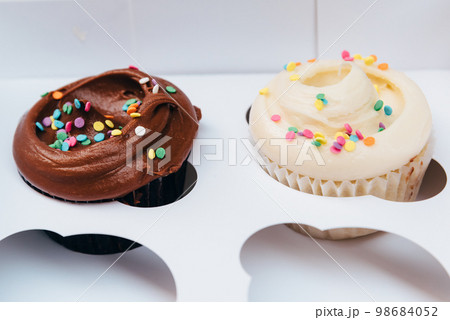 Assorted Gourmet Tasty Cupcakes on a Carboard Box Assorted Gourmet Tasty Cupcakes on a Carboard Box 98684052