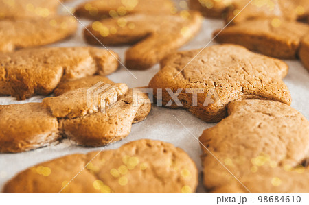 Close up of Christmas pastries,  gingerbread cookies, ready to eat traditional Xmas and New Year pastry on white paper. 98684610