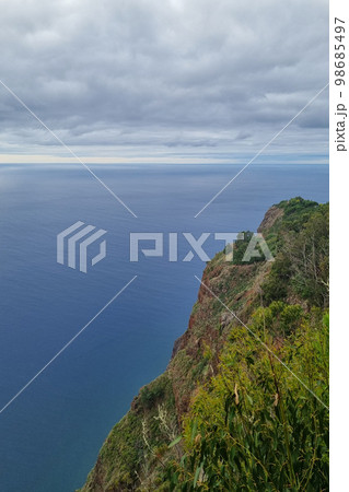 The green slope of a mountain on an island in the Atlantic Ocean. 98685497