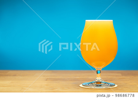 Full tulip glass of NEIPA beer on a table 98686778