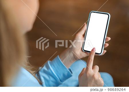 Unrecognizable Woman Using Smartphone With Blank White Screen Indoors Unrecognizable Woman Using Smartphone With Blank White Screen Indoors 98689264