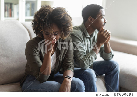 Upset black woman crying after quarrel with husband 98690093