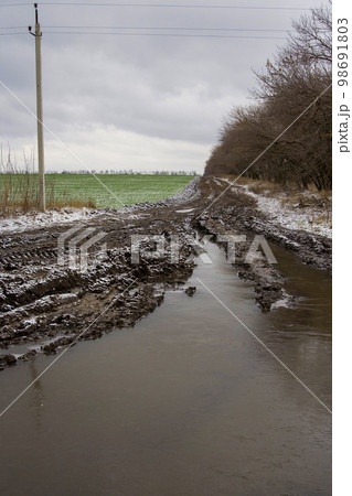 Winter rural landscape with a bad road Winter rural landscape with a bad road 98691803