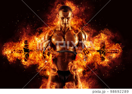 The shirtless abdominal male holds dumbbell. Studio shot in contrasty light The shirtless abdominal male holds dumbbell. Studio shot in contrasty light 98692289