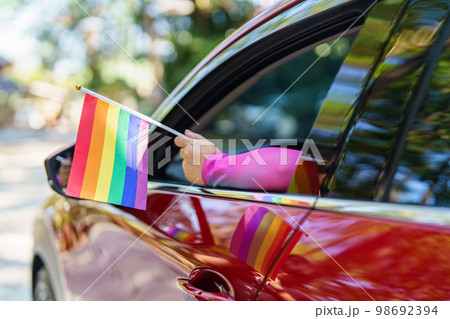 Happy Asian woman support LGBT pride parade in car. with Rainbow of LGBTQ or LGBTQIA. Happy Asian woman support LGBT pride parade in car. with Rainbow of LGBTQ or LGBTQIA. 98692394