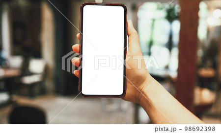 Women's hands holding cell telephone blank copy space screen. smartphone with blank white screen isolated on white background . smart phone with technology concept 98692398