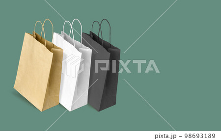 Paper bags for shopping on green background. Copy space 98693189