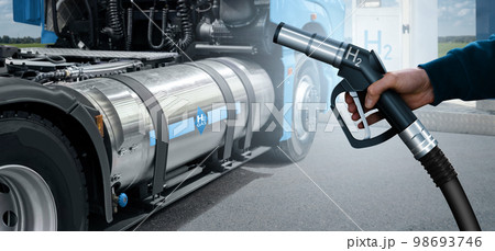 Hand with H2 nozzle on a background of hydrogen fuel cell semi truck 98693746