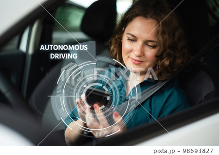 Woman driver controls an autonomous car 98693827